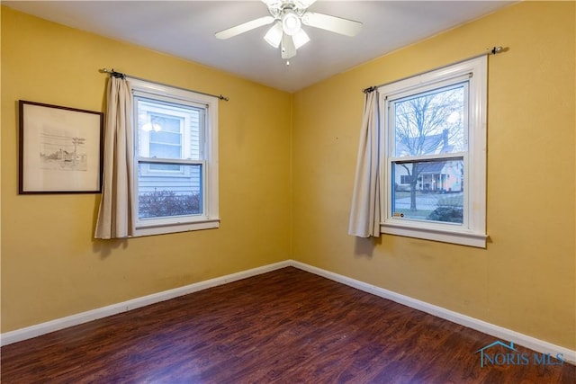 unfurnished room featuring ceiling fan and dark hardwood / wood-style floors