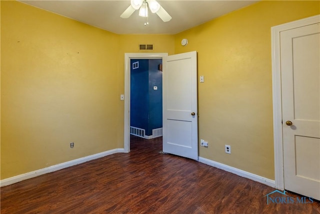 unfurnished bedroom featuring ceiling fan and dark hardwood / wood-style floors