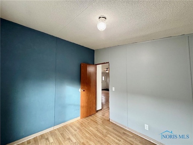 empty room featuring light hardwood / wood-style floors and a textured ceiling