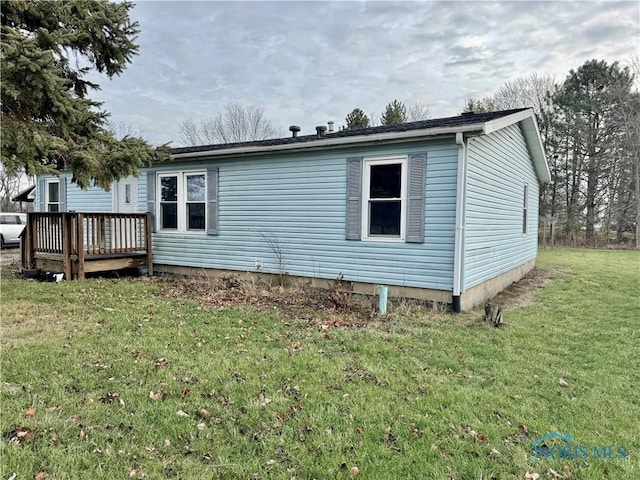 exterior space with a yard and a wooden deck