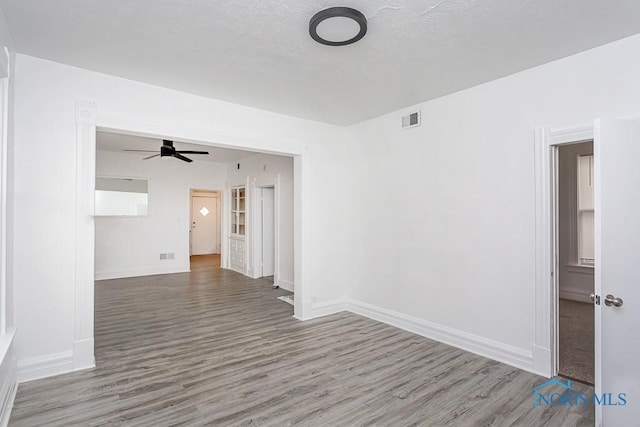 empty room featuring ceiling fan and wood-type flooring