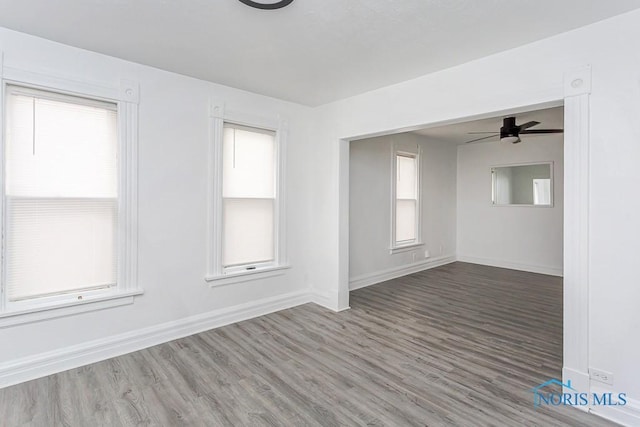 empty room with hardwood / wood-style flooring and ceiling fan