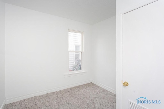 empty room with carpet flooring