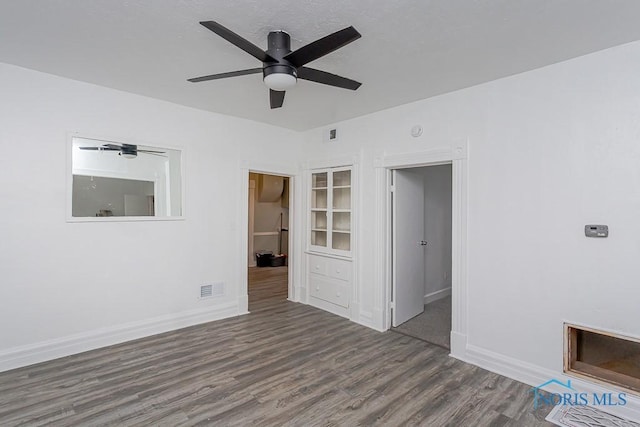 spare room featuring dark hardwood / wood-style floors and ceiling fan