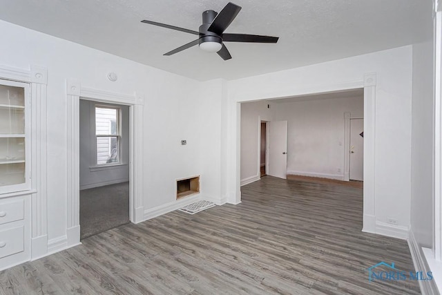 empty room featuring ceiling fan and wood-type flooring