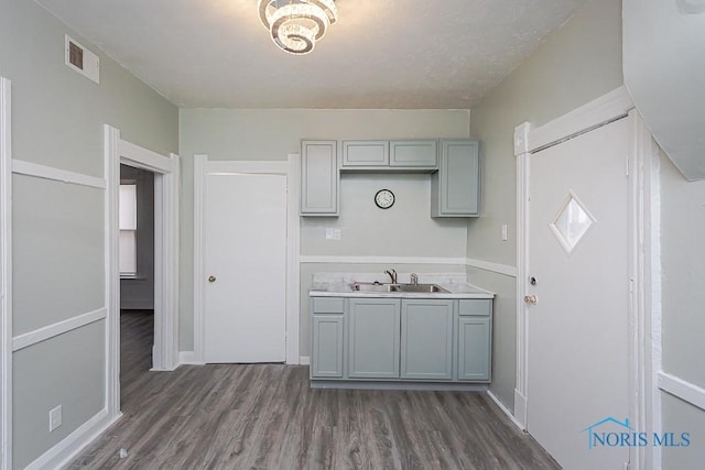 kitchen featuring gray cabinets, dark wood-type flooring, and sink