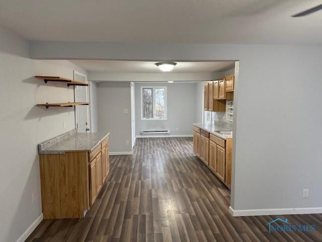 kitchen with decorative backsplash, dark wood-type flooring, and a baseboard heating unit