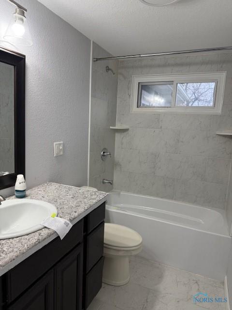 full bathroom featuring vanity, toilet, and tiled shower / bath