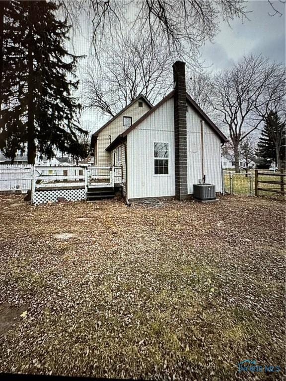 view of home's exterior featuring central AC unit and a deck