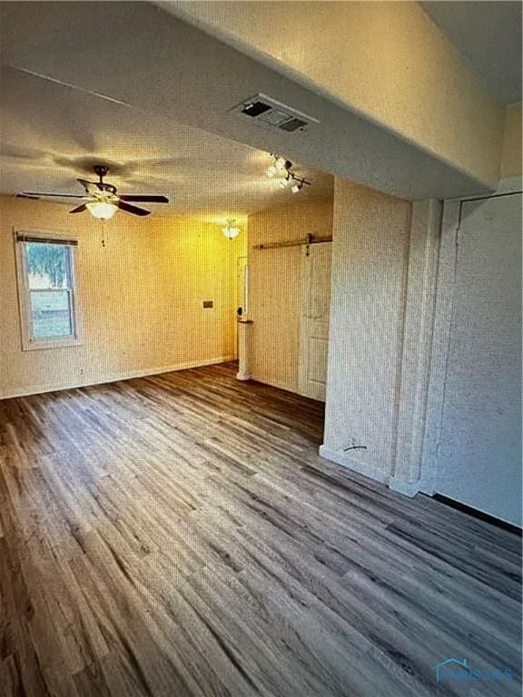 bonus room featuring ceiling fan and dark hardwood / wood-style flooring