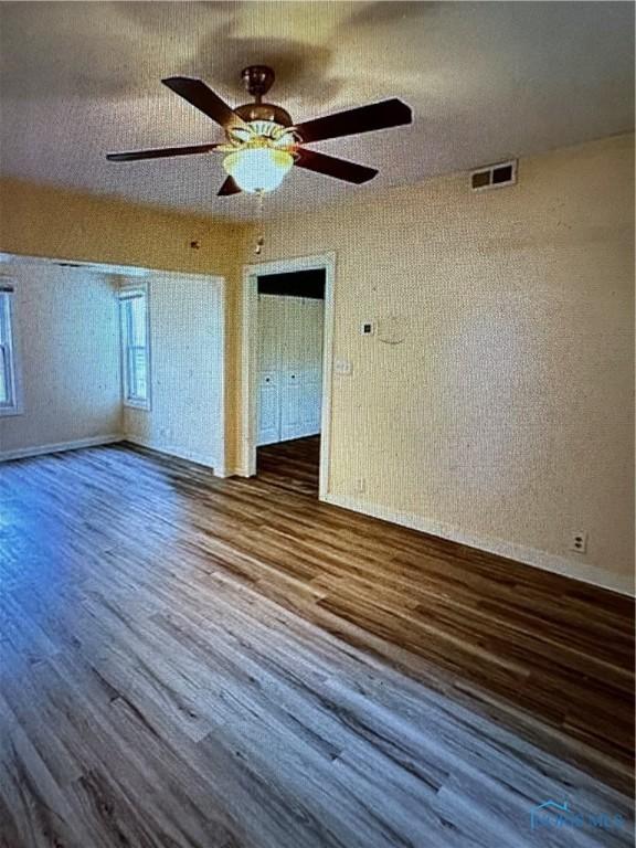 empty room featuring hardwood / wood-style floors, a textured ceiling, and ceiling fan