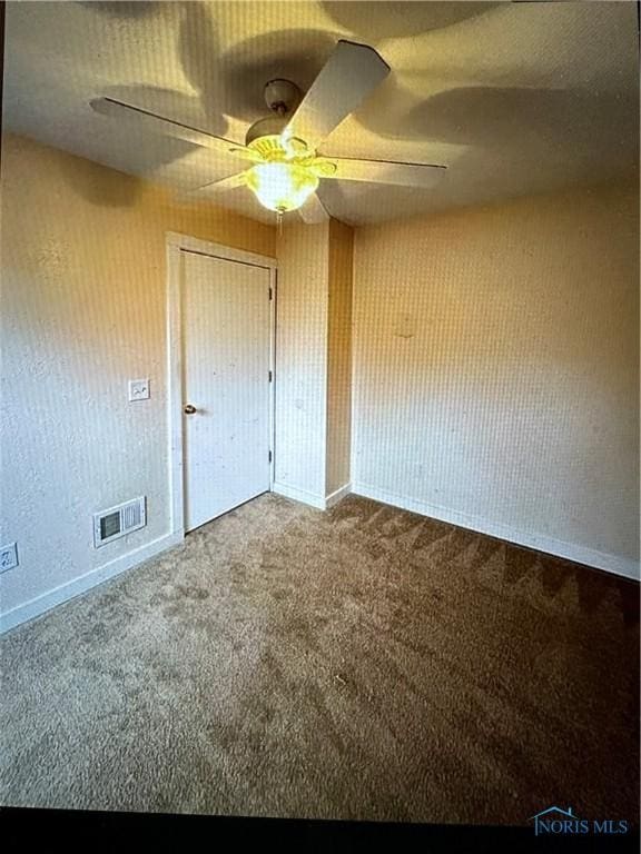 unfurnished bedroom with carpet floors, a closet, and ceiling fan