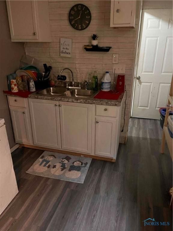 kitchen featuring white cabinetry, sink, and dark hardwood / wood-style floors