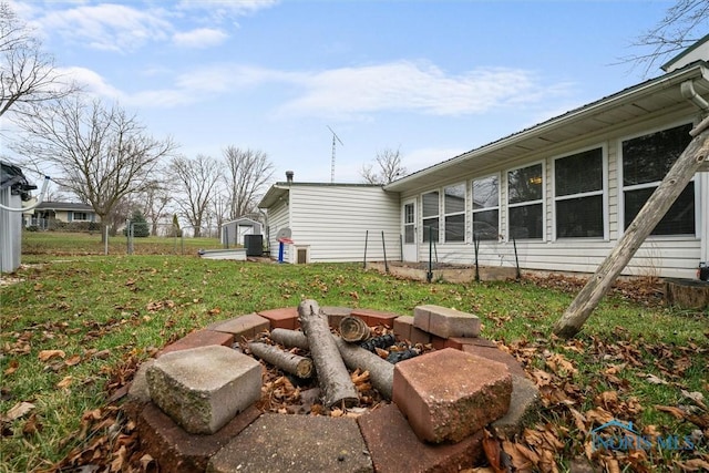 view of yard featuring an outbuilding, a storage shed, and fence