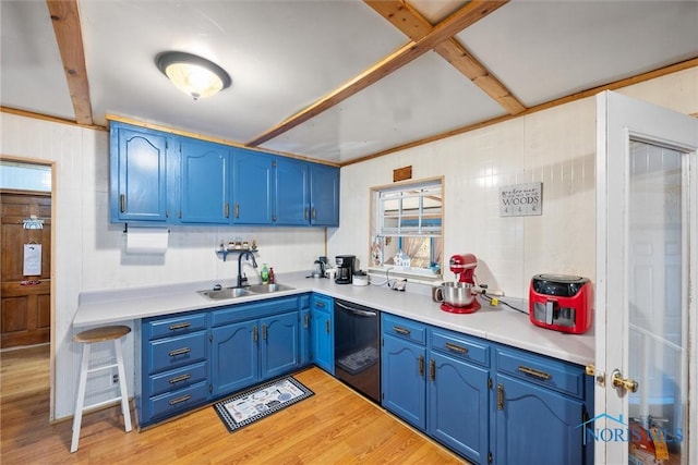 kitchen with blue cabinetry, stainless steel dishwasher, light wood-type flooring, and a sink