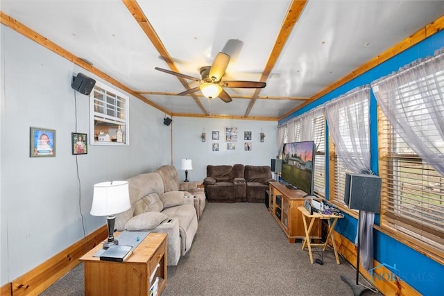 carpeted living area with ceiling fan