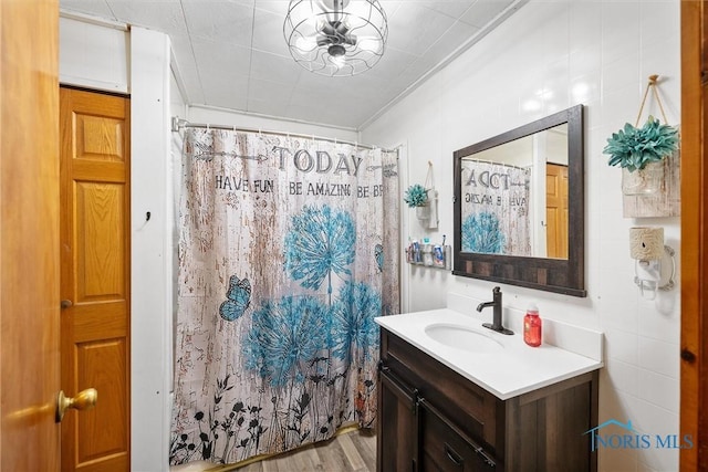 bathroom featuring ornamental molding, vanity, wood-type flooring, and a shower with shower curtain