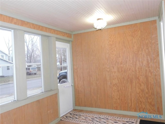 entryway with wooden walls