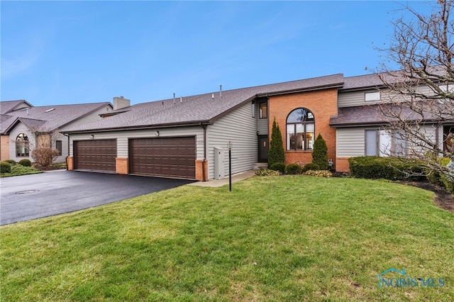 ranch-style home with a garage and a front yard