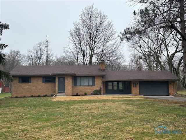 single story home featuring a garage and a front yard