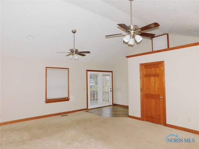 unfurnished room featuring ceiling fan, french doors, carpet, and lofted ceiling