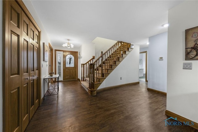 entrance foyer with dark hardwood / wood-style flooring and a chandelier