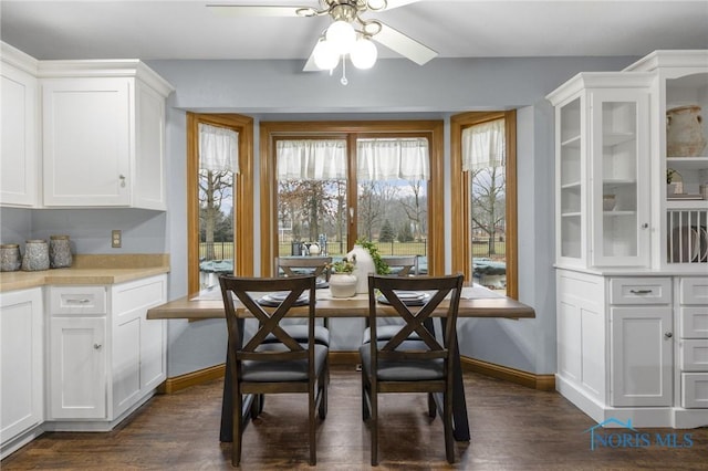 dining area with breakfast area, ceiling fan, and dark wood-type flooring