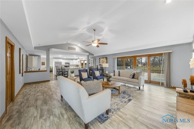 living room featuring ceiling fan and lofted ceiling