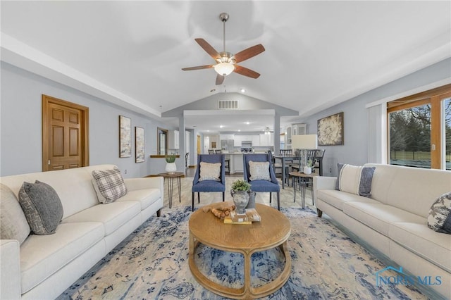 living room featuring ceiling fan and lofted ceiling