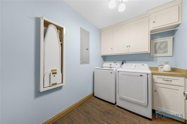 washroom featuring cabinets, dark hardwood / wood-style flooring, electric panel, and washer and dryer