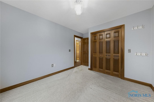 unfurnished bedroom with carpet floors and a closet