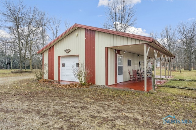 view of outbuilding with covered porch and a garage