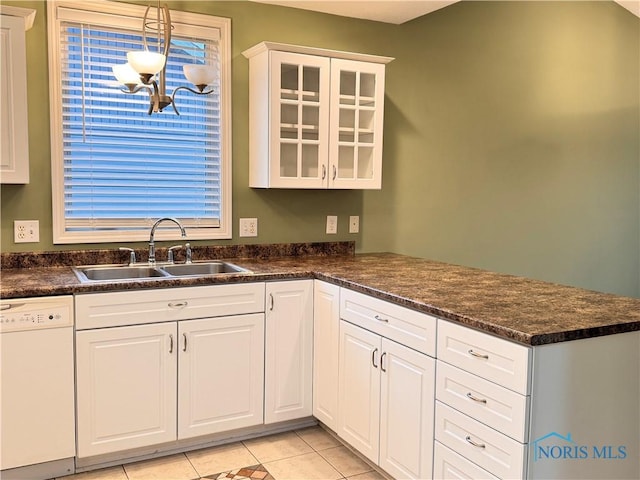 kitchen with sink, hanging light fixtures, white cabinets, white dishwasher, and light tile patterned flooring