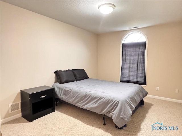 bedroom featuring light carpet