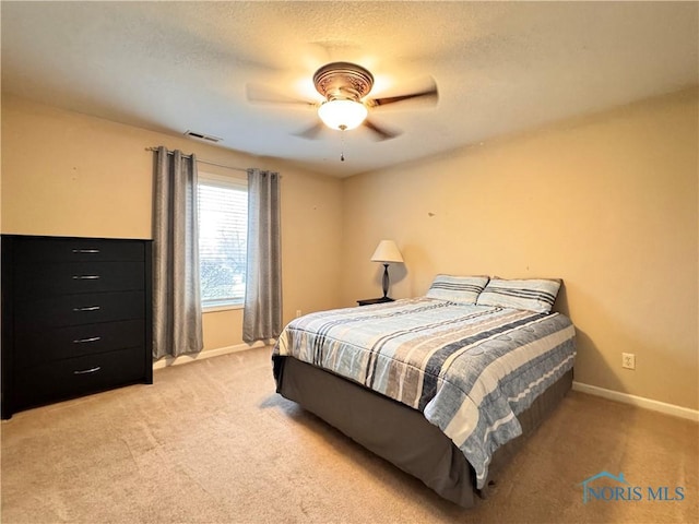 bedroom with ceiling fan and light carpet