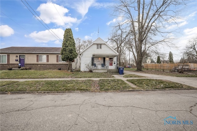 view of front of home with a front lawn and a porch