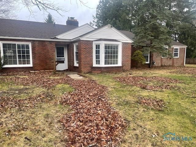 ranch-style house with a front lawn