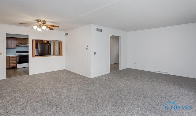 unfurnished living room featuring ceiling fan and dark colored carpet