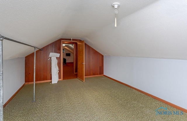 bonus room with carpet flooring, a textured ceiling, and lofted ceiling