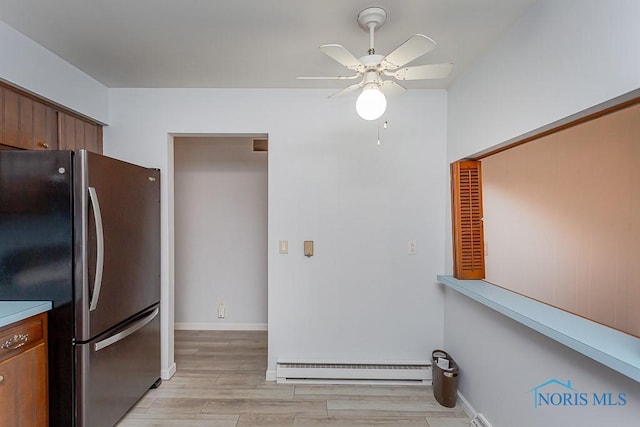 kitchen with ceiling fan, light hardwood / wood-style floors, stainless steel refrigerator, and a baseboard radiator