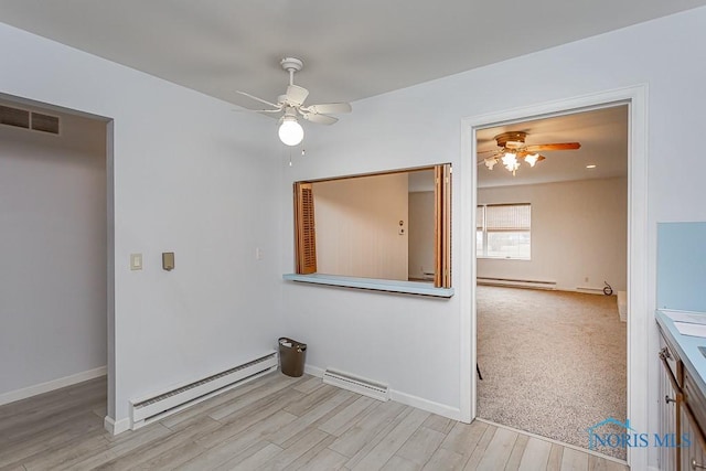 interior space with ceiling fan, light hardwood / wood-style flooring, and a baseboard radiator