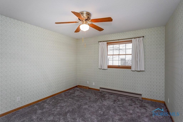 empty room with baseboard heating, ceiling fan, and dark colored carpet