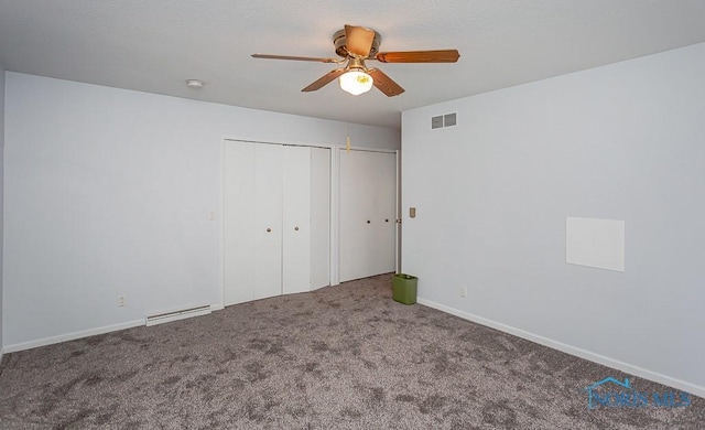 unfurnished bedroom with multiple closets, ceiling fan, and carpet