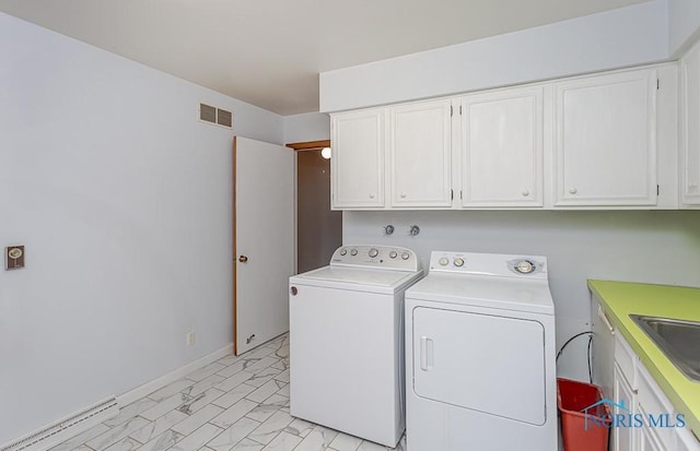 laundry room featuring cabinets and independent washer and dryer