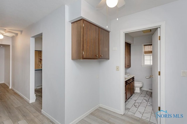 bathroom with vanity, toilet, and ceiling fan