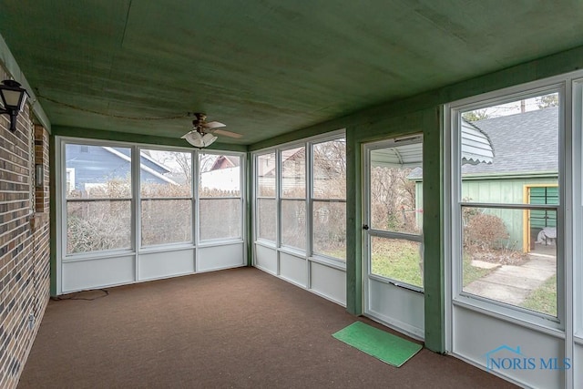 unfurnished sunroom with ceiling fan and a healthy amount of sunlight