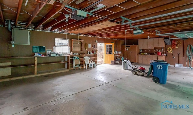 garage with a workshop area and a garage door opener