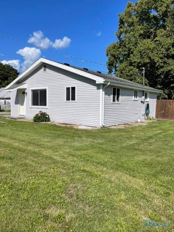 view of side of home with a lawn