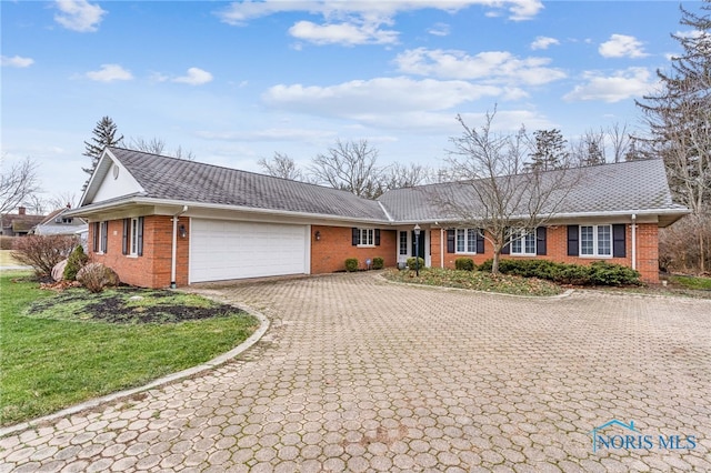 ranch-style house with a garage and a front yard