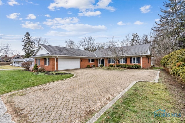 ranch-style home featuring a garage and a front lawn